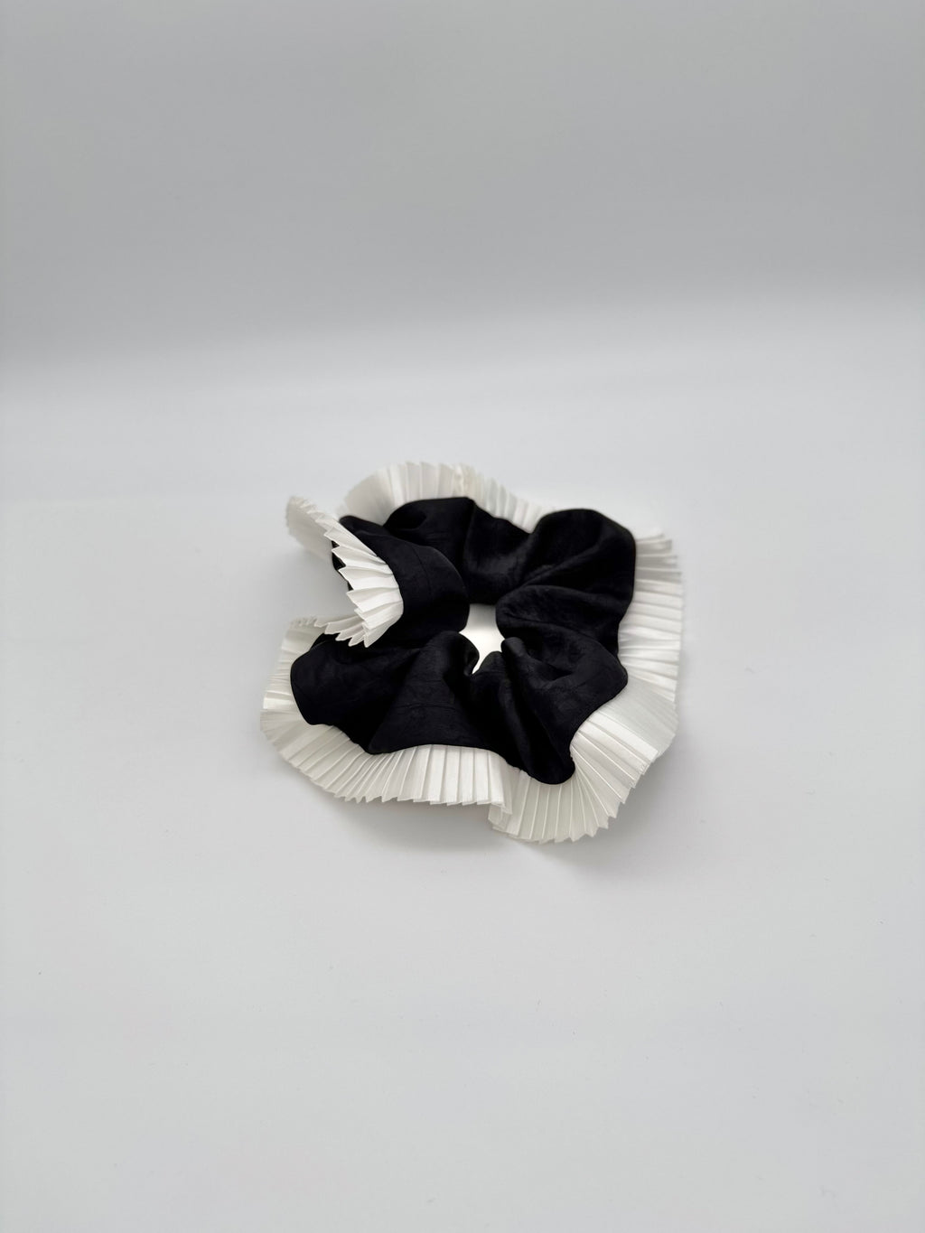 Elegance – Black Silk-Style Scrunchie with Pleated White Trim